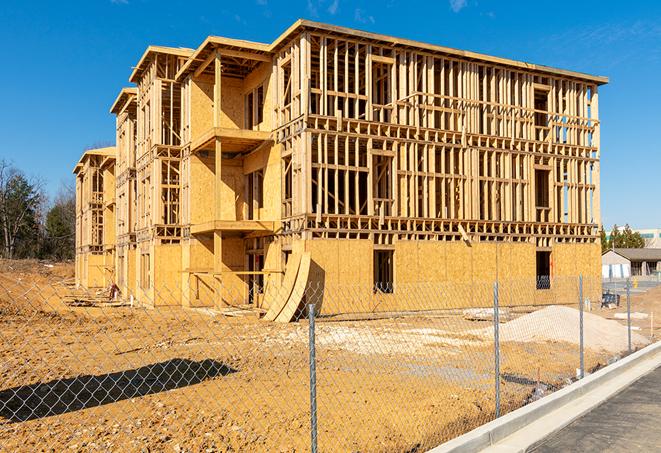 a close-up of temporary chain link fences enclosing a construction site, signaling progress in the project's development in Montgomery Village, MD